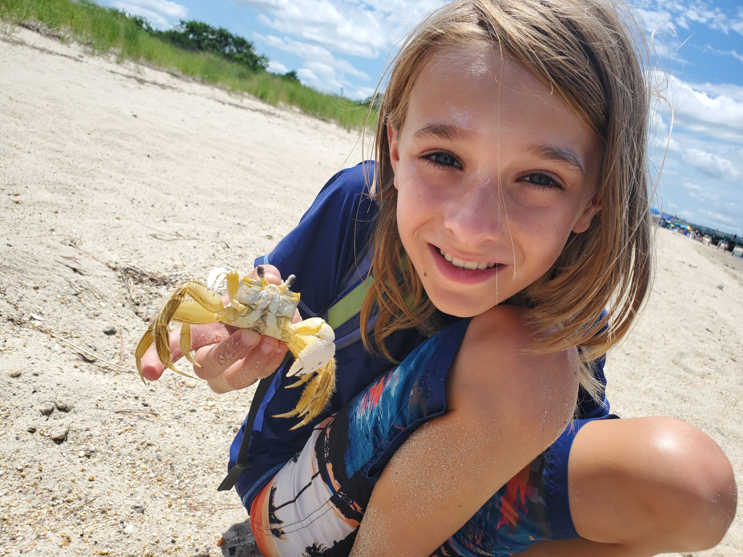 Child outdoors with crab by Christi Leeson